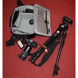 A Nikon F4 digital camera in soft carry case with further accessories to include tripod etc