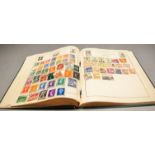 A stamp album and a quantity of loose stamps, some worldwide, mainly UK