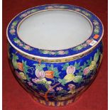 A Chinese jardiniere, on a blue ground decorated with butterflies amongst trees and foliage,