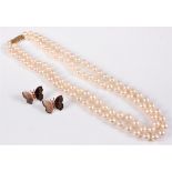 A two strand cultured pearl necklace, the uniform pearls approx. 6.8mm, with 9ct clasp, 39cm long,