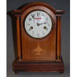 An Edwardian mahogany and satinwood inlaid cased mantel clock of architectural form having a