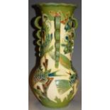 A large Lauder Barum Devon pottery vase, having triple ring handles, on a cream ground with