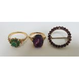 A 9ct emerald cluster ring, London 1975, size N, an amethyst ring stamped '9ct', size I, and a