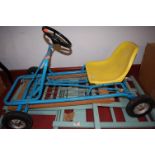 A dolls cot and a childs metal framed go-cart etc