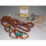 A box of assorted to jewellery to include a seed pod necklace, mother of pearl beads, faux pearls,
