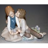 A Lladro figure group boy & girl in seated post holding flowers, printed mark verso, height 16cm