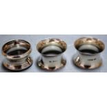 A pair of Edwardian silver napkin rings together with one other silver example (3)