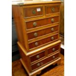 A small reproduction yew wood and crossbanded chest, of four short and four long drawers, on bracket