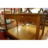 An early 20th century light oak single drawer writing table, w.150cm