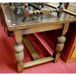 A moulded oak drawleaf dining table, raised on carved baluster supports to low H-stretcher, max