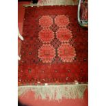 A Persian woollen red ground Bokhara rug, having flatweave kelim and tassled ends, 150 x 102cm