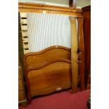 A French mahogany double lit-en-bateau, having twin side rails, fixed slatted base section, and