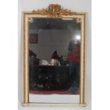 A 19th century cream painted giltwood and gesso wall mirror, having a rectangular plate surmounted