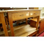 An early 20th century light oak two drawer writing table, w.106cm