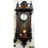 An early 20th century walnut and ebonised Vienna drop trunk wall clock