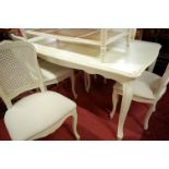 A contemporary French style cream painted dining suite, comprising extending dining table with