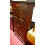 A George III mahogany and satinwood strung freestanding corner cupboard, having twin recessed arched