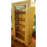 A 1930s limed oak single door lead glazed bookcase, width 61cm