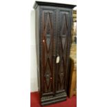 An unusual early 20th century stained and relief carved oak double door narrow side cupboard, w.