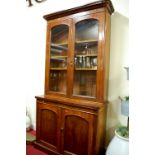 A mid-Victorian mahogany round cornered bookcase cupboard, width 127cm