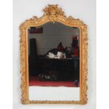A mid-Victorian giltwood and gesso overmantel mirror, having an arched bevel plate within an 'S'