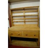 A Victorian pine round cornered kitchen dresser, having two-tier open plate rack over twin deep