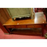 A contemporary hardwood rectangular two-tier low coffee table, having three frieze drawers, width