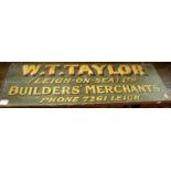 An early 20th century painted oak double-sided shop sign for W.T. Taylor Builders Merchants