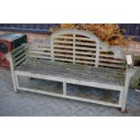 A slatted teak three seater Luytens garden bench, width 175cm