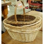 A pair of modern wicker twin handled baskets; together with a further wicker basket (3)