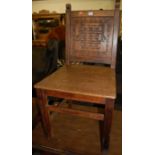 A joined and relief carved oak panelled seat hall chair