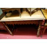 An early 20th century carved oak ledgeback hall table, raised on bobbin turned supports, w.104cm