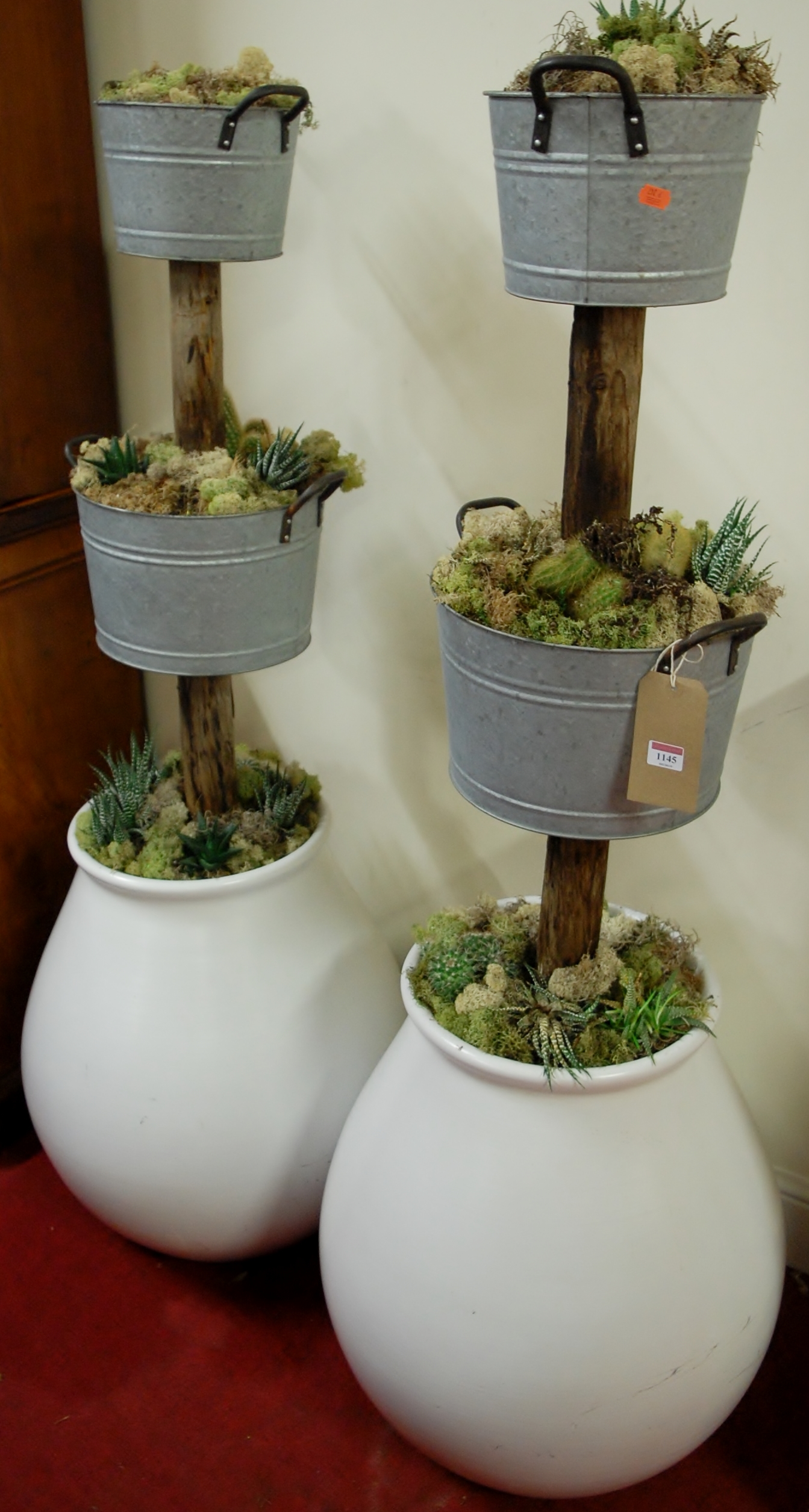 A pair of contemporary three tier planters, the upper tiers as galvanised buckets to lower bulbous