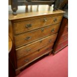 An early 19th century provincial oak chest of four long graduated drawers, raised on bracket