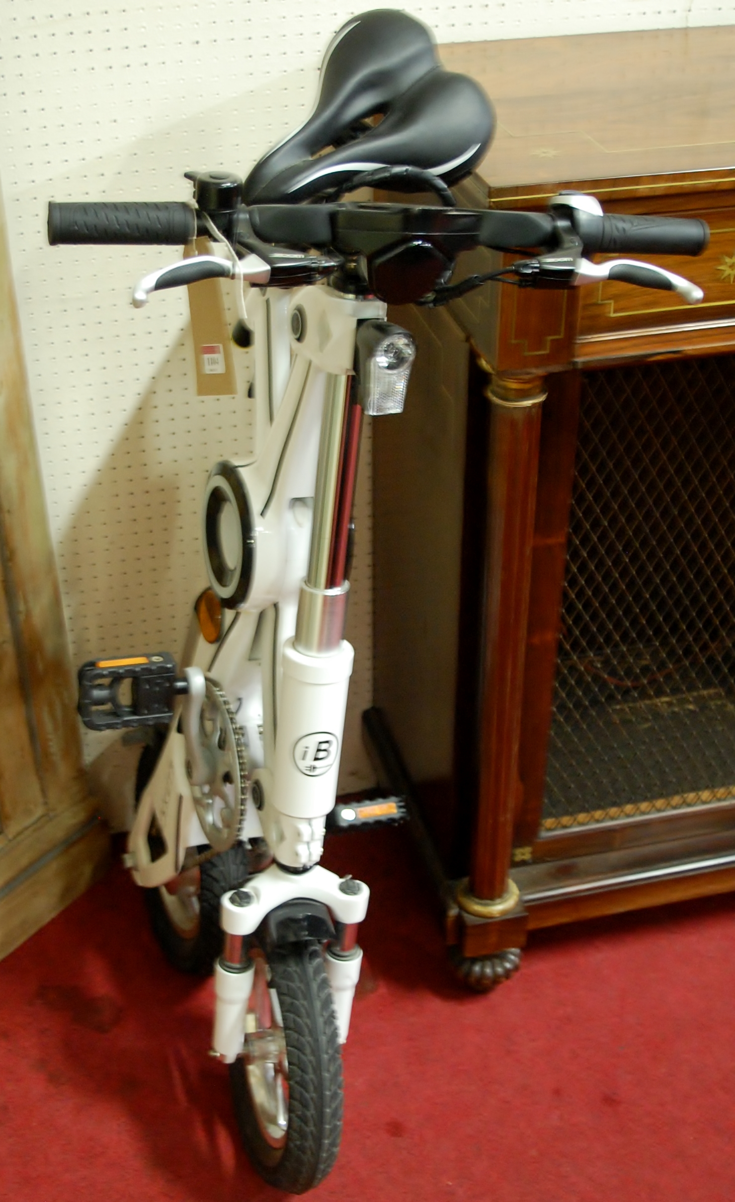 An Eskuta folding electric bike with charging pack and accessories