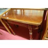 An early 19th century mahogany round cornered fold-over games table, on turned supports, w.90cm