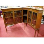 An unusual pair of mahogany and satinwood strung corner cabinets, each having four astragal glazed