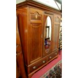 A circa 1900 mahogany, satinwood crossbanded and further inlaid three door wardrobe, having