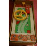 A Bandai of Japan tinplate and plastic driving text style game, comprising tin-printed conveyor belt