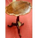 A 19th century mahogany shaped top fixed pedestal tripod occasional table