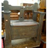 An early 20th cenutry oak boxseat settle, with pierced stickstand arm rests,, w.83.5cm