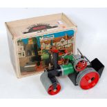 A Mamod SR1A steam roller comprising green, black and red steam roller with burner scuttle, steering