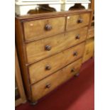 A Victorian mahogany chest, of two short over three long drawers, raised on squat turned supports,