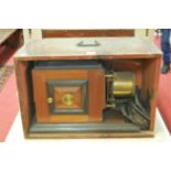 An early 20th century mahogany cased plate-camera, with sundry slides