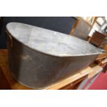 A galvanised metal bath having end carry handles, length 135cm