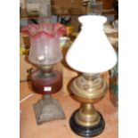 A circa 1900 cranberry glass oil lamp, with cranberry reservoir and frosted cranberry shade;