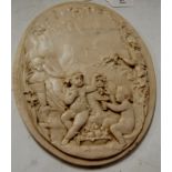 A marble plaque relief decorated with Bacchanalian scene having bronze roundel verso marked "