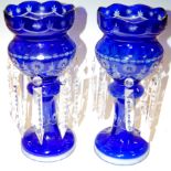 A pair of Bohemian style blue overlaid glass lustres with clear glass prism drops together with