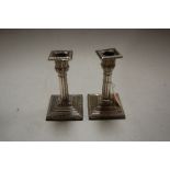 A pair of Victorian silver table candlesticks, each having removable sconce above acanthus leaf