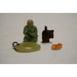 A polished green hardstone pendant; a Chinese polished and carved agate pendant; a jadeite Buddha